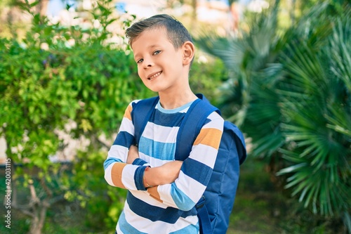 dorable caucasian student boy smiling happy standing at the park.