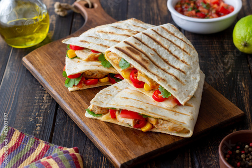 Quesadilla with chicken, tomatoes, corn, cheese and chilli. Mexican food. Fast food.