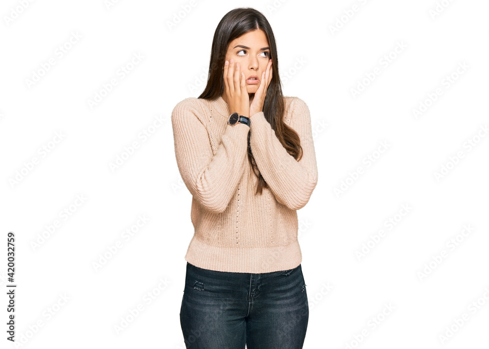 Young brunette woman wearing casual winter sweater tired hands covering face, depression and sadness, upset and irritated for problem