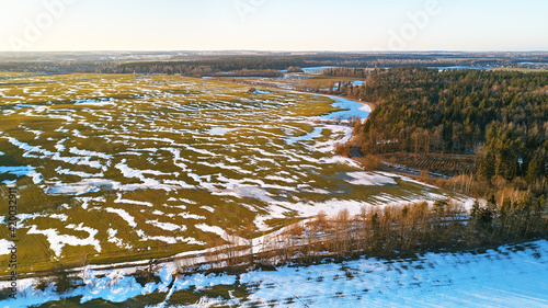 Obraz na płótnie Season change. March rural landscape. Winter crops and plowed field panorama. w salonie