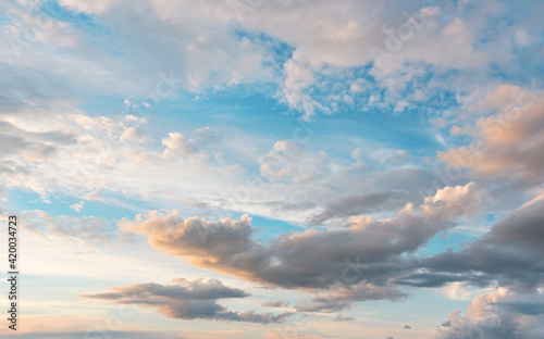 Evening sky with some yellow, white, grey and dark clouds