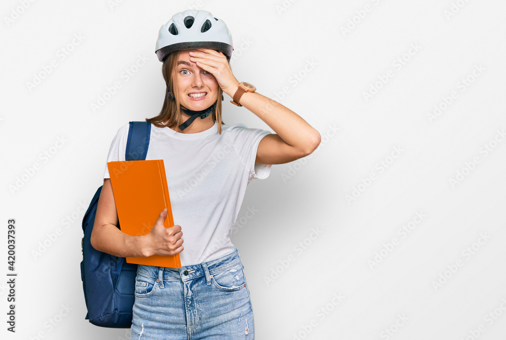 Beautiful young blonde woman wearing backpack and bike helmet stressed and frustrated with hand on head, surprised and angry face Beautiful young blonde woman wearing backpack and bike helmet stressed and frustrated with hand on head, surprised and angry face