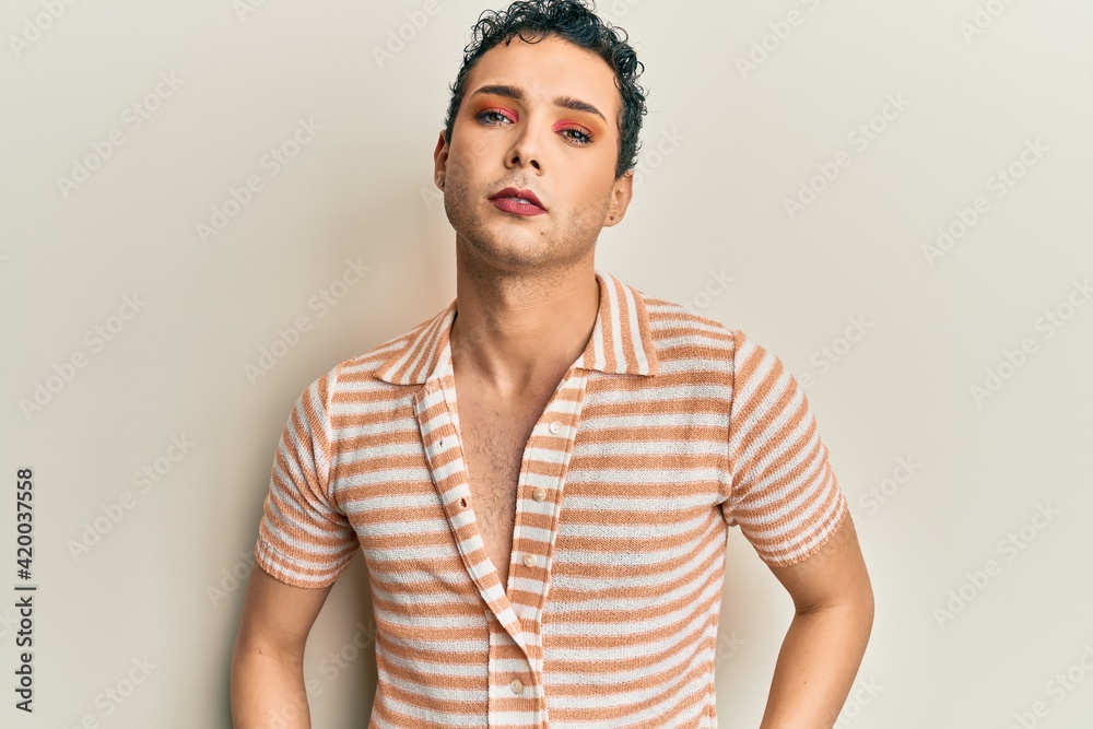 Handsome man wearing make up wearing casual shirt scared and amazed with open mouth for surprise, disbelief face Handsome man wearing make up wearing casual shirt scared and amazed with open mouth for surprise, disbelief face