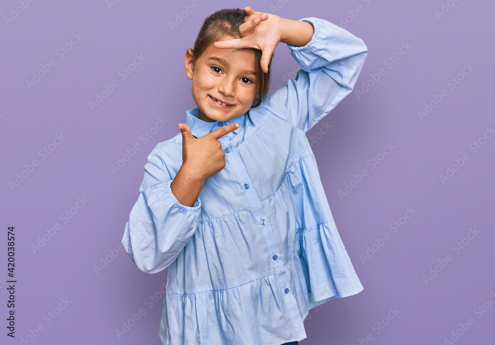 Little beautiful girl wearing casual clothes smiling making frame with hands and fingers with happy face. creativity and photography concept.