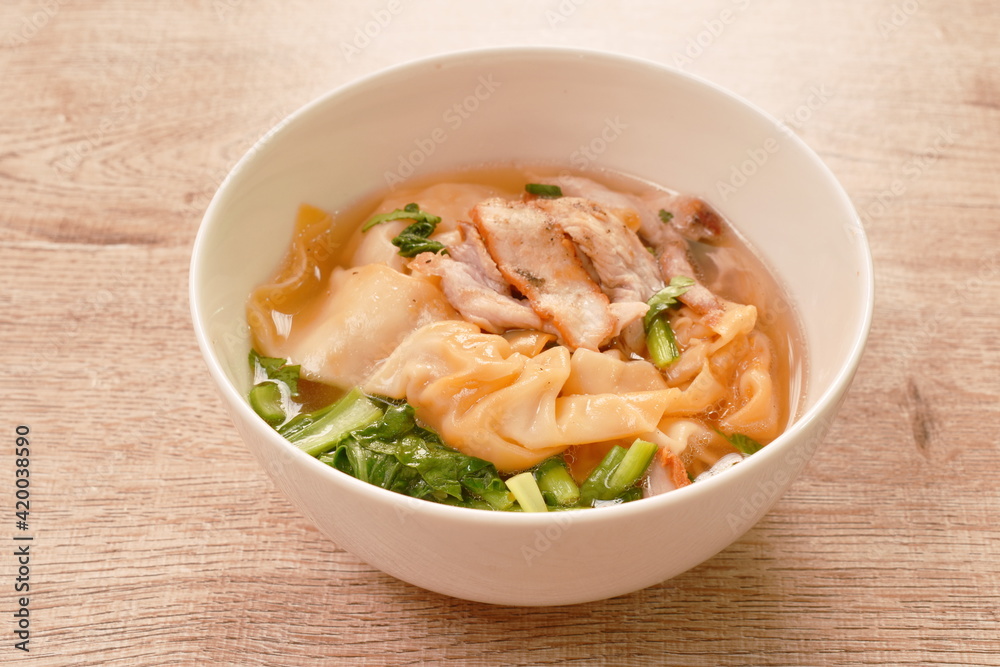 Chinese dumpling topping slice red barbrcue pork with clear soup on bowl Chinese dumpling topping slice red barbrcue pork with clear soup on bowl