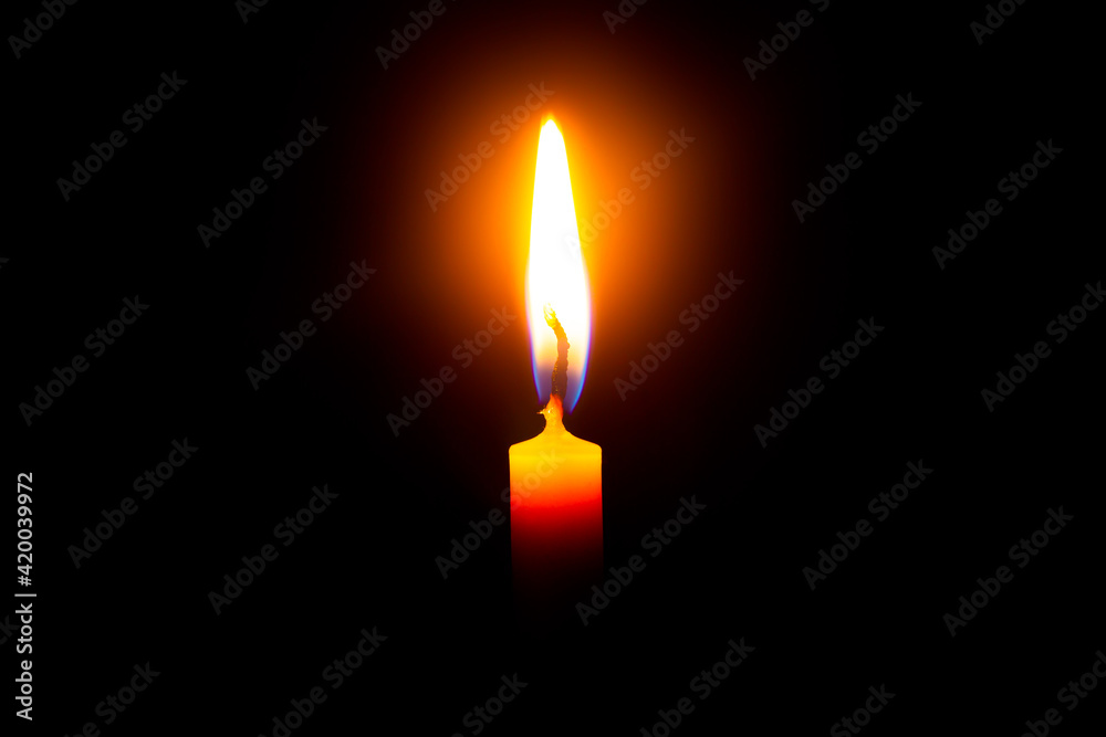 Close up single candle light and flame on black background Close up single candle light and flame on black background