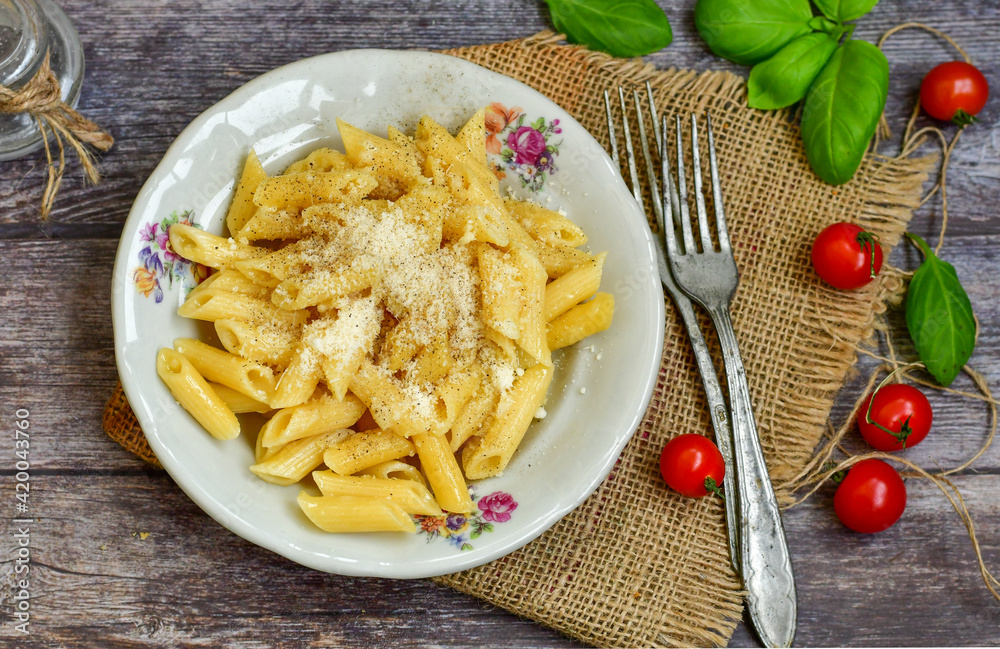 Home made italian penne rigate pasta with parmesan cheese,garlic and black pepper .Pasta cacio e pepe. Mediterranean food concept Home made italian penne rigate pasta with parmesan cheese,garlic and black pepper .Pasta cacio e pepe. Mediterranean food concept
