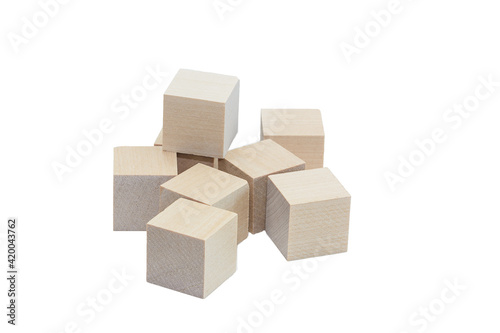 Wooden cubes are scattered randomly. Isolated over white background