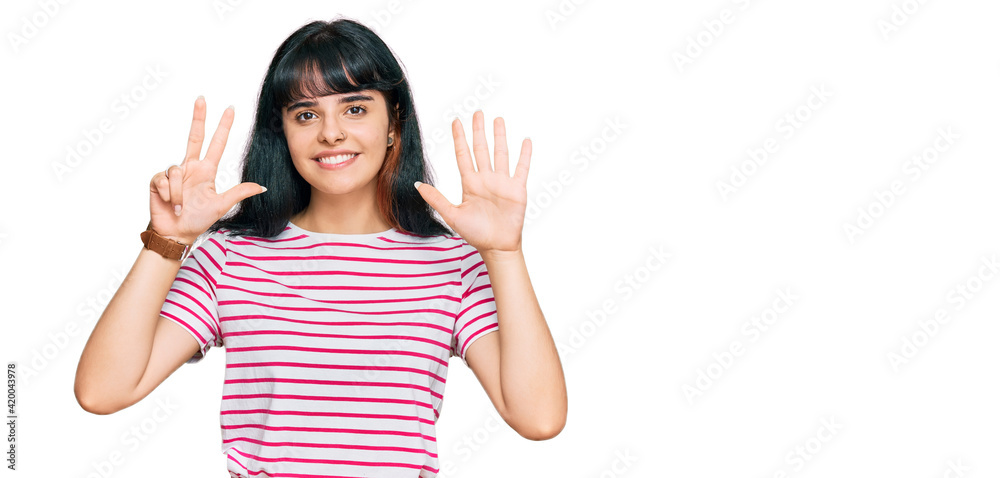 Young hispanic girl wearing casual clothes showing and pointing up with fingers number eight while smiling confident and happy. Young hispanic girl wearing casual clothes showing and pointing up with fingers number eight while smiling confident and happy.