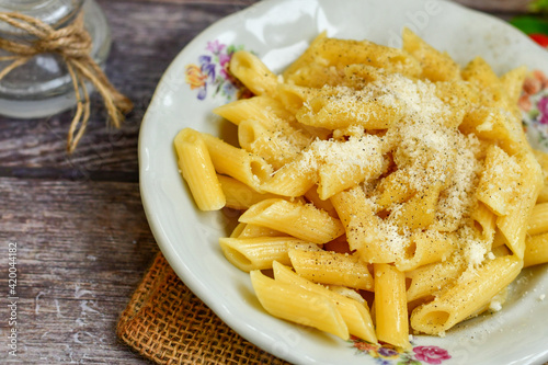  Home made italian penne rigate pasta with parmesan cheese,garlic and black pepper .Pasta cacio e pepe. 