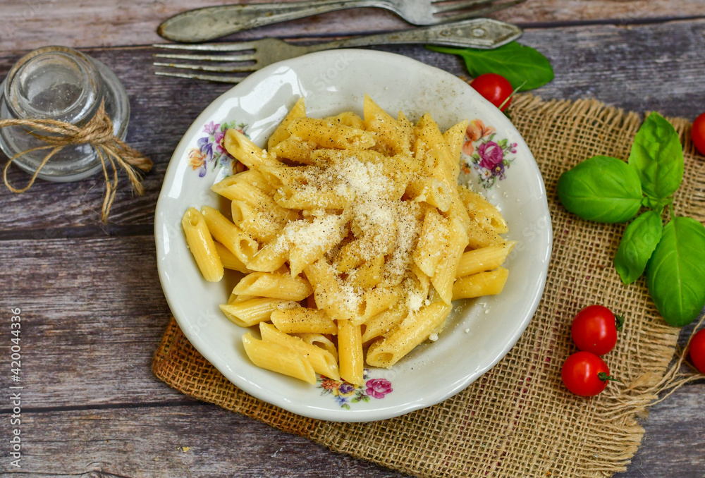  Home made  italian penne rigate pasta  with parmesan cheese,garlic  and black pepper .Pasta cacio e pepe. 