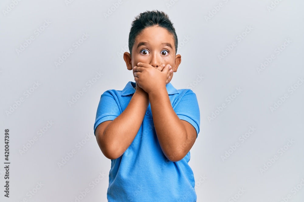 Little boy hispanic kid wearing casual clothes shocked covering mouth with hands for mistake. secret concept.