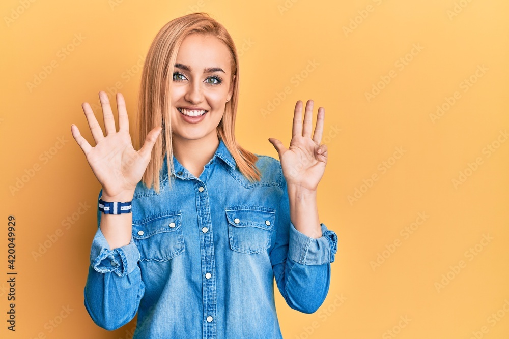 Beautiful caucasian woman wearing casual denim jacket showing and pointing up with fingers number nine while smiling confident and happy. Beautiful caucasian woman wearing casual denim jacket showing and pointing up with fingers number nine while smiling confident and happy.