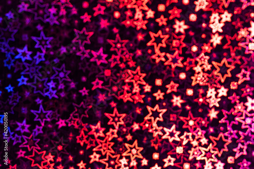 Multicolored stars shimmer in different shades, starry bokeh, background