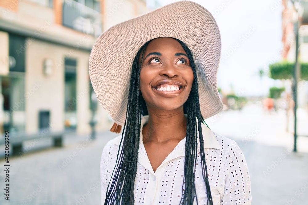 Young african american woman on vacation smiling happy walking at street of city