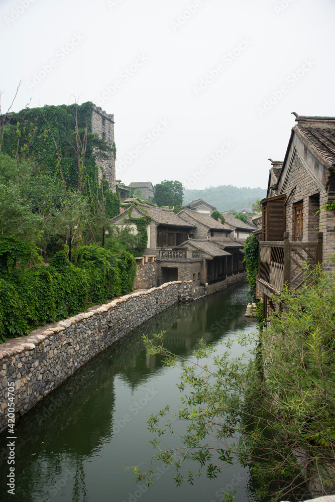 Small and touristic medieval european village on the bank of a river