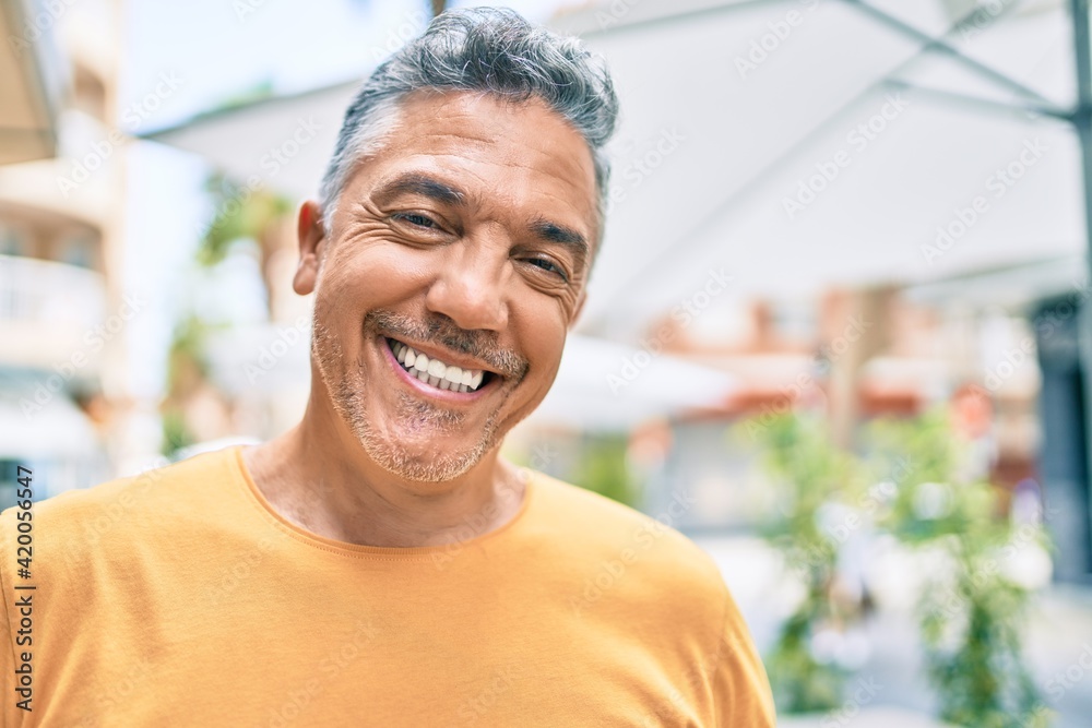 Middle age grey-haired man smiling happy walking at street of city. Middle age grey-haired man smiling happy walking at street of city.
