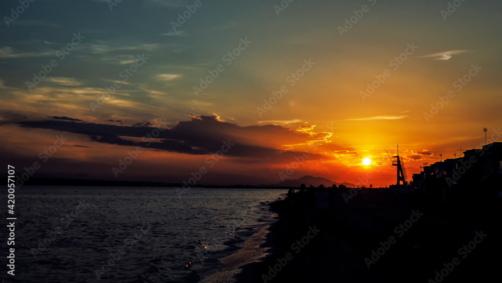 Paisaje al atardecer en una playa de Santa Pola con el mar y una torre de vigilancia