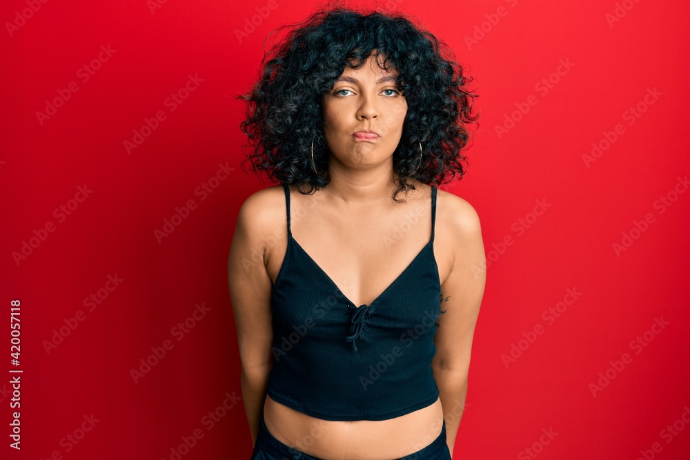 Young hispanic woman wearing casual style with sleeveless shirt depressed and worry for distress, crying angry and afraid. sad expression. Young hispanic woman wearing casual style with sleeveless shirt depressed and worry for distress, crying angry and afraid. sad expression.