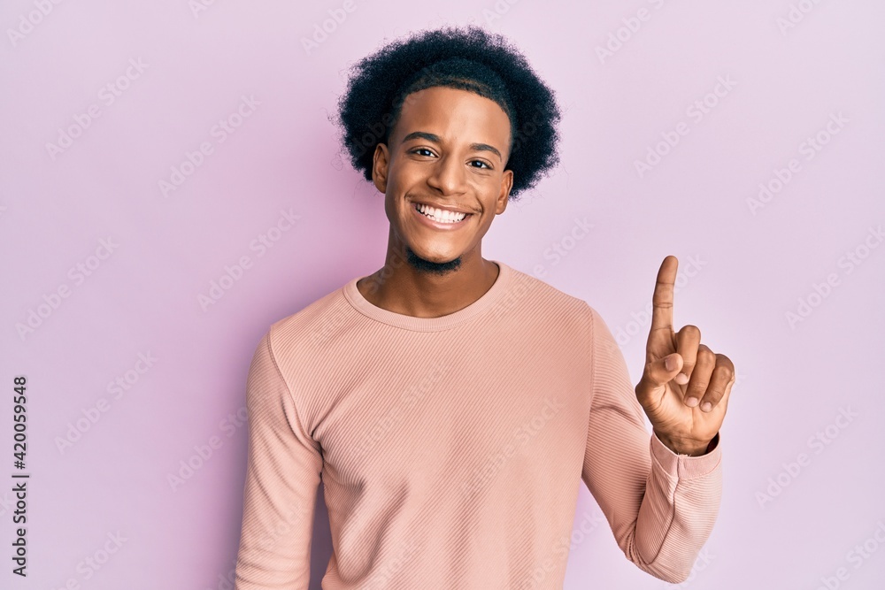 African american man with afro hair wearing casual clothes smiling with an idea or question pointing finger up with happy face, number one African american man with afro hair wearing casual clothes smiling with an idea or question pointing finger up with happy face, number one