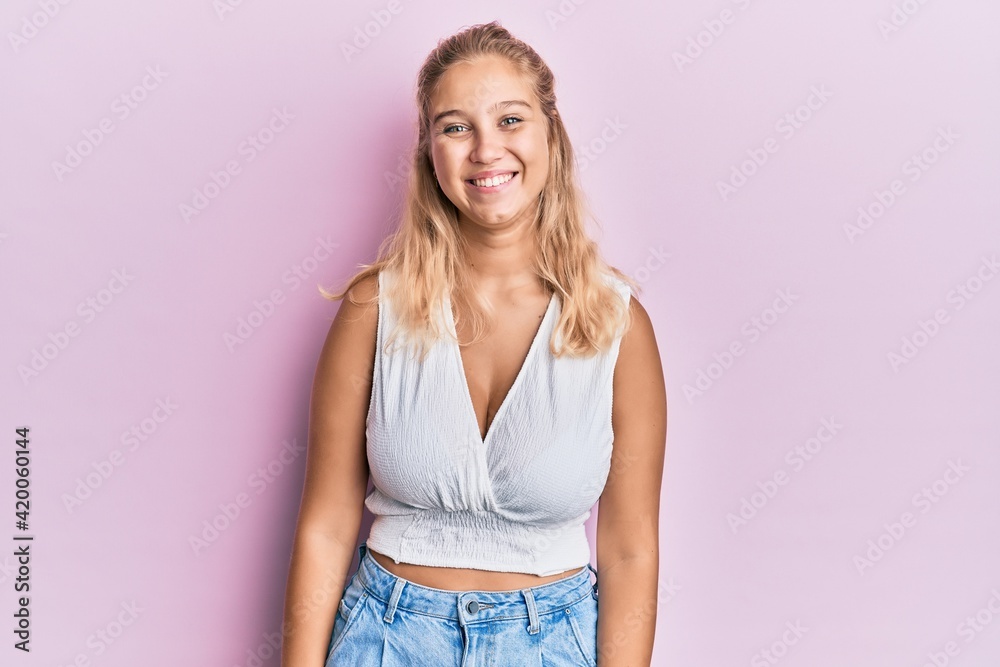 Young blonde girl wearing casual clothes with a happy and cool smile on face. lucky person. Young blonde girl wearing casual clothes with a happy and cool smile on face. lucky person.