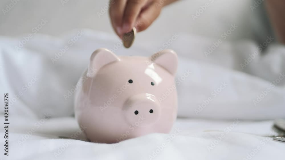 Happy family. Child put coins in a piggy bank. Saving money concept. Happy family. Child put coins in a piggy bank. Saving money concept.