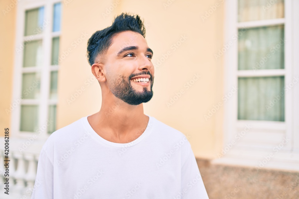 Young arab man smiling happy walking at the city. Young arab man smiling happy walking at the city.