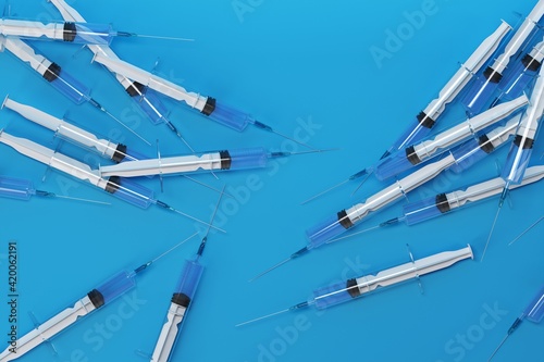 Wallpaper Mural Medical Syringes with Needle on Blue Background, Close up Syringe, Health care concept. 3d Illustration Torontodigital.ca