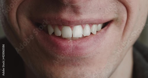 Close-up mouth of shocked young man is smiling, macro shot. Portrait of happy smile man.