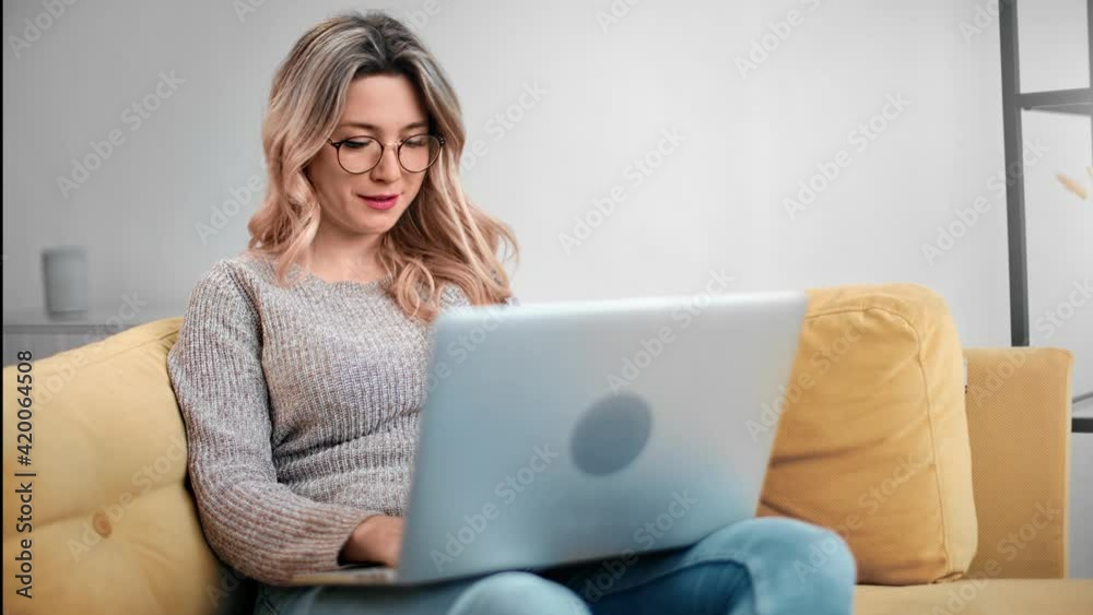 Happy freelancer lady smiling chatting work remote on laptop pc. Shot with RED camera in 4K Happy freelancer lady smiling chatting work remote on laptop pc. Shot with RED camera in 4K