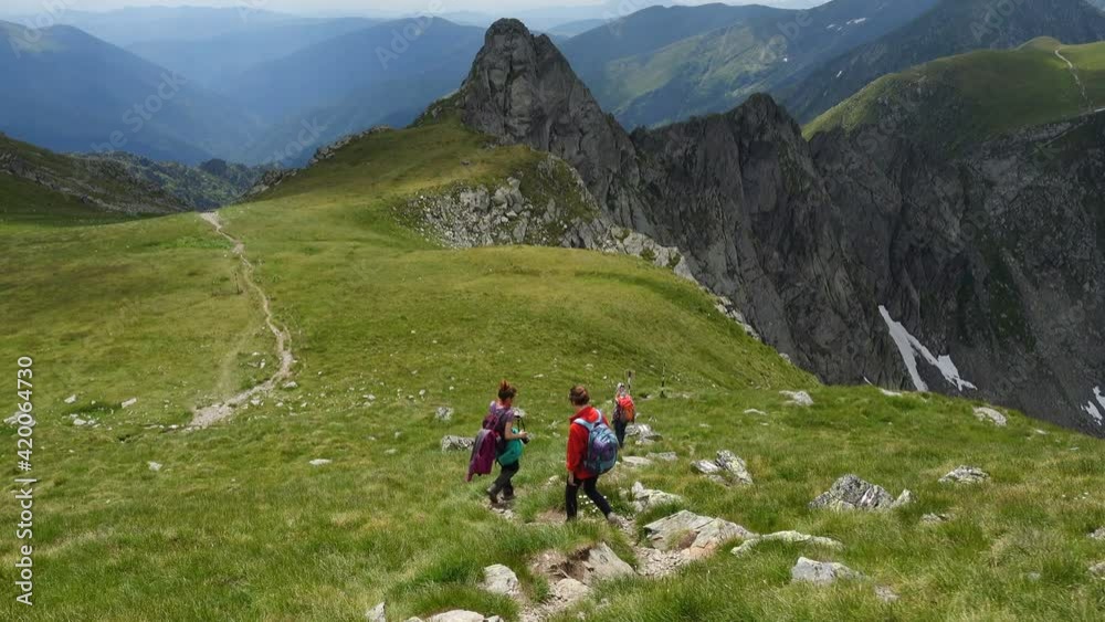 mother with daughters hiking by the Fagaras ridge in the romanian mountains at the summer
mother with daughters hiking by the Fagaras ridge in the romanian mountains at the summer