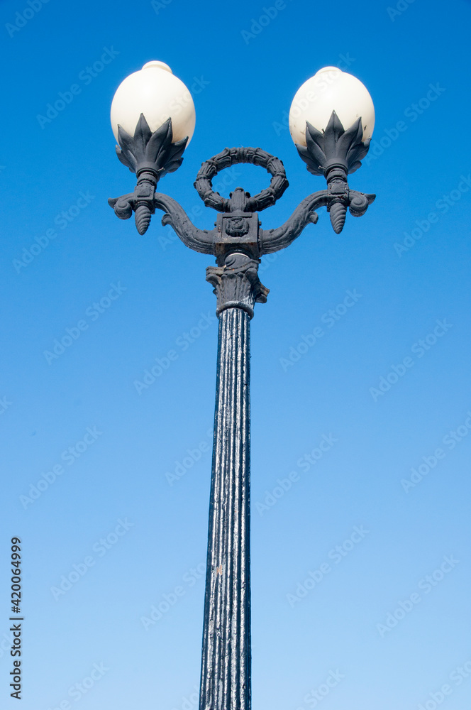 Lighting park lamp against the blue sky. Garden lamp with white shades. Lighting park lamp against the blue sky. Garden lamp with white shades.