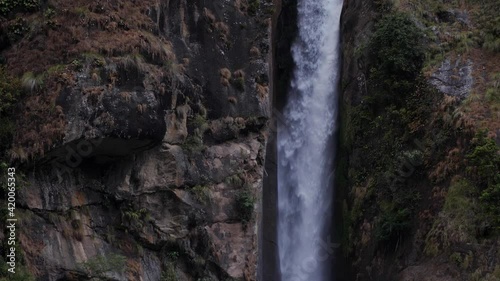 60 fps. Nepal. Pan of waterfall in Chyamche village. photo