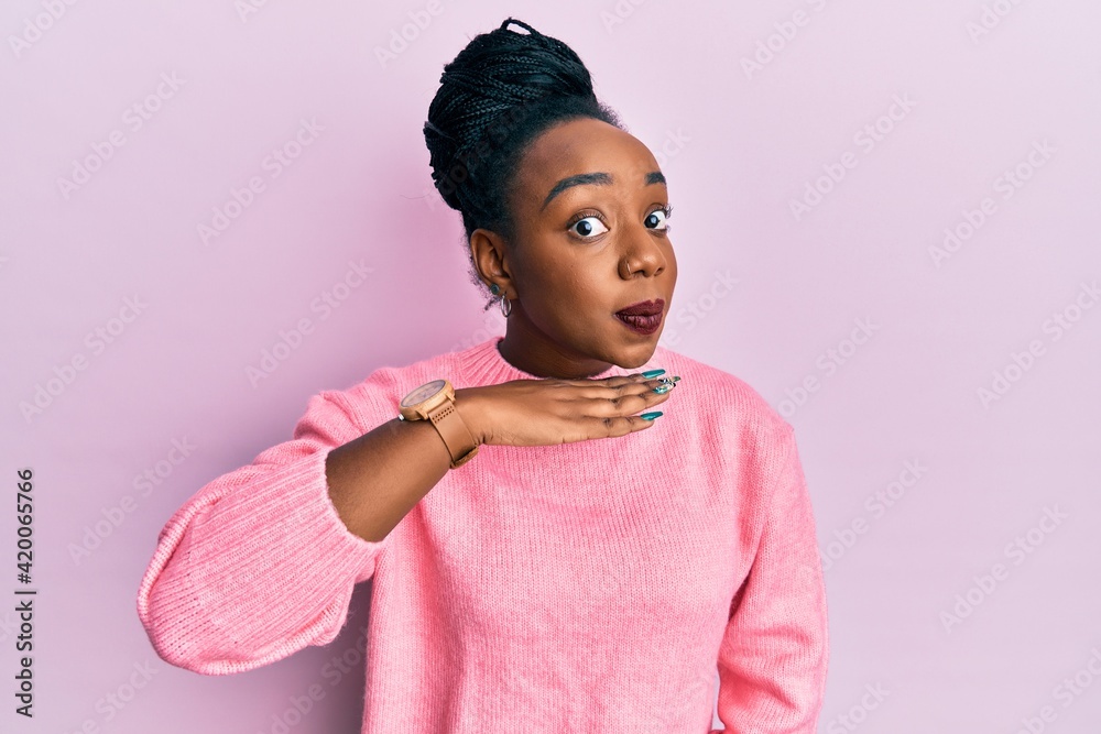 Young african american woman wearing casual winter sweater cutting throat with hand as knife, threaten aggression with furious violence Young african american woman wearing casual winter sweater cutting throat with hand as knife, threaten aggression with furious violence