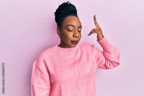Obraz na plátne Young african american woman wearing casual winter sweater shooting and killing oneself pointing hand and fingers to head like gun, suicide gesture