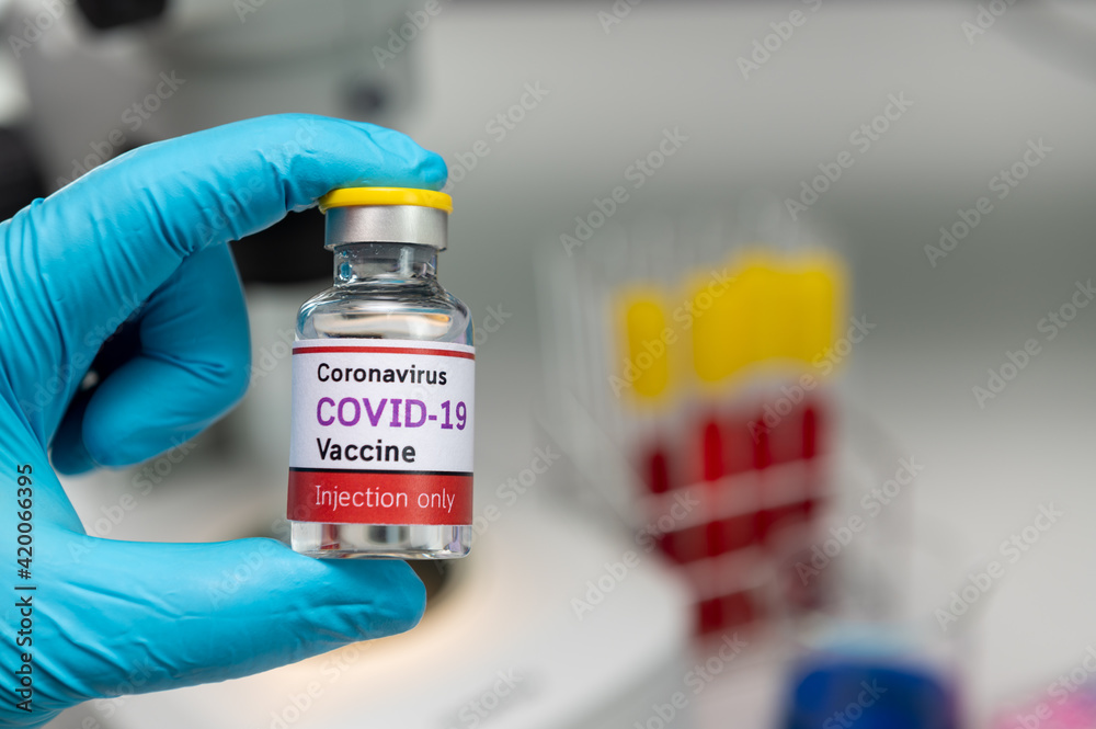 Covid 19 vaccine bottle in hand of scientist