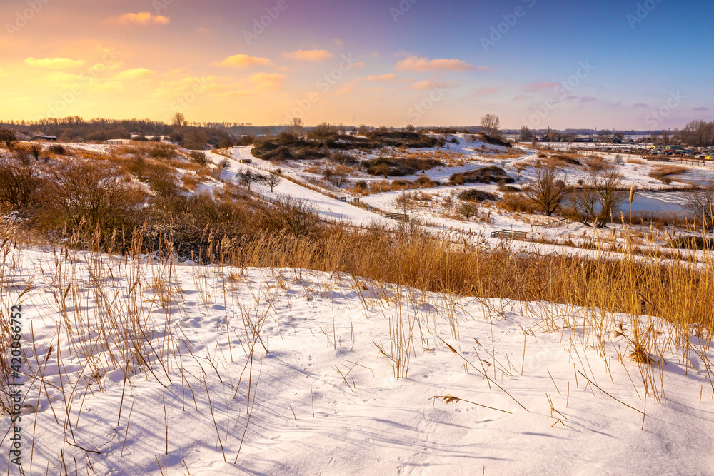 Snowy landscape with hills and meadows in Buytenpark Zoetermeer, the Netherlands