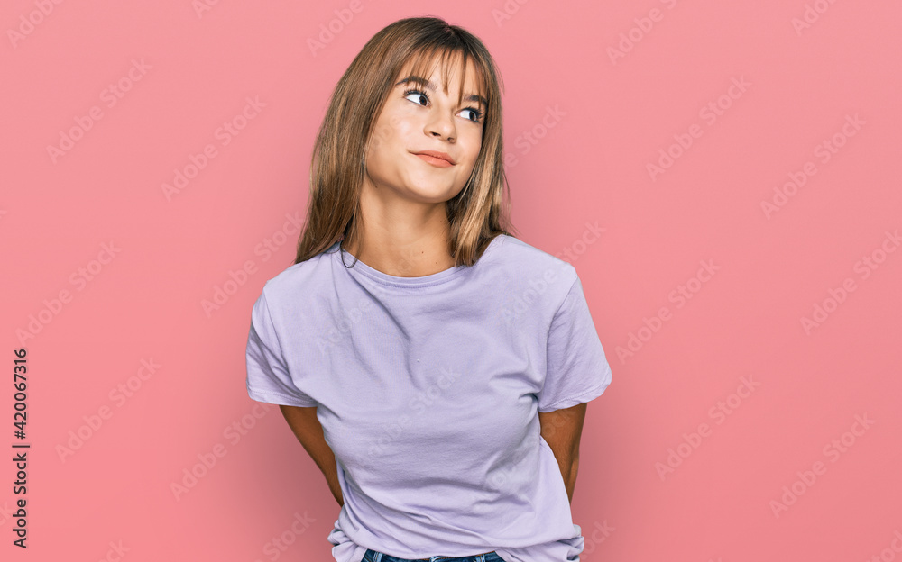 Obraz premium Teenager caucasian girl wearing casual clothes smiling looking to the side and staring away thinking.