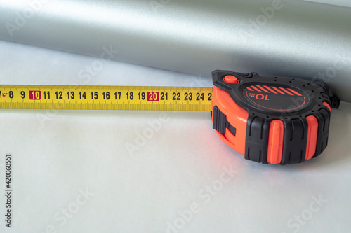 Working tape measure on a light background.