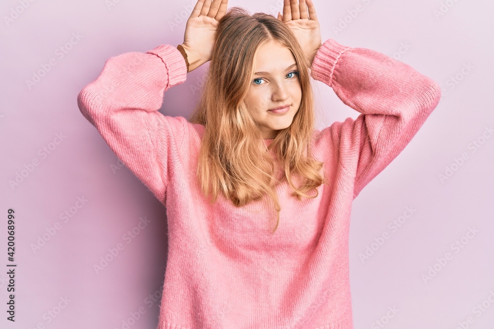 Beautiful young caucasian girl wearing casual clothes doing bunny ears gesture with hands palms looking cynical and skeptical. easter rabbit concept.