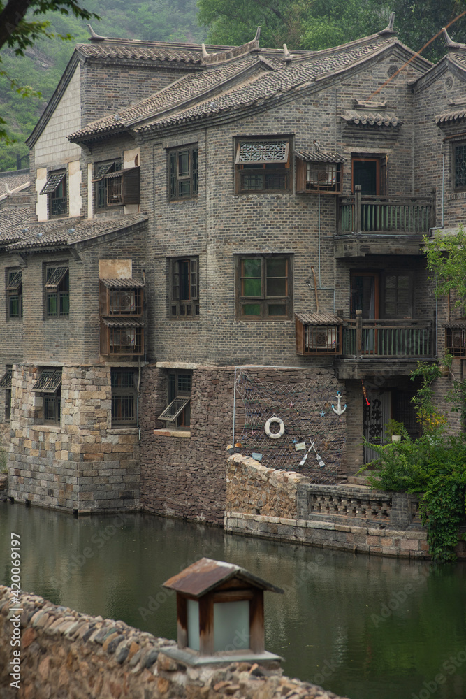 Small and touristic medieval european village on the bank of a river