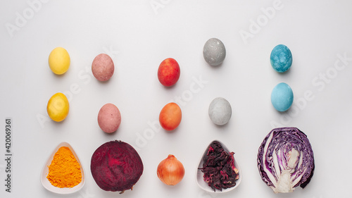 Natural dye for easter eggs - red cabbage, beetroot, carcade, turmeric and onion skin on light background