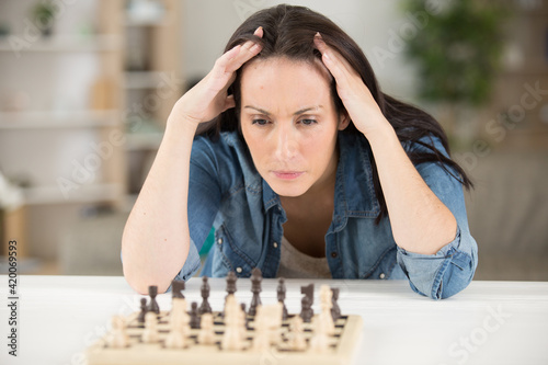 close-up shot of smiling young woman playing chess