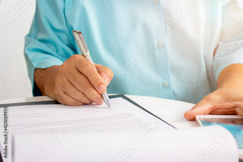 The older woman sign contract for health insurance at home