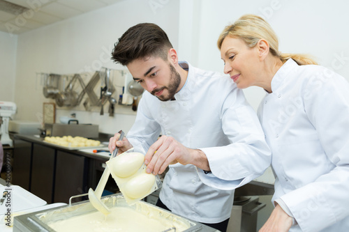 caucasian male and female chef make chocolate sweets