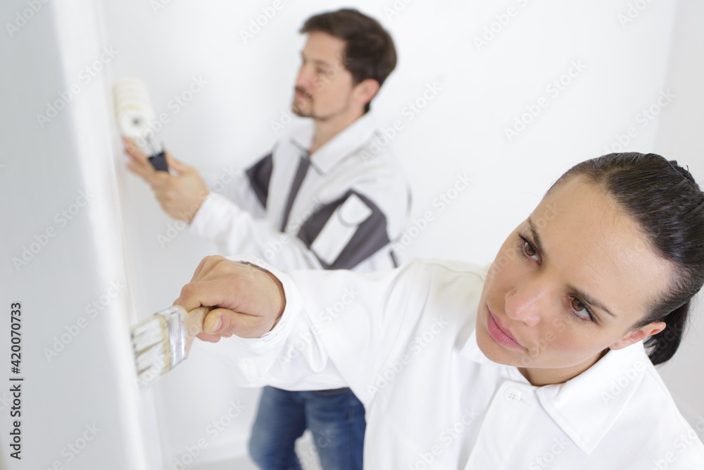 male and female decorating team working together male and female decorating team working together