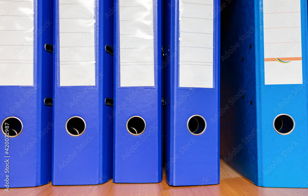 blue folders for papers on a shelf close-up blue folders for papers on a shelf close-up
