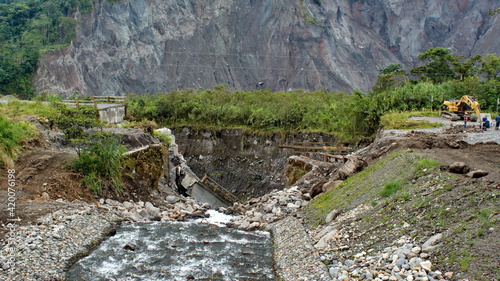 Collapsed road on the edge of an eroded river gorge near El Reventador Volcano in Napo province, Ecuador photo