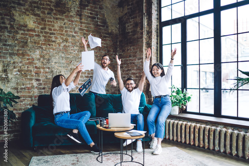 Wallpaper Mural Joyful multiethnic coworkers celebrating success in workspace Torontodigital.ca