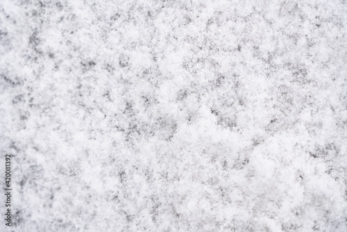 Abstract background in the form of snow on the asphalt